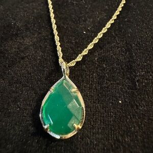 Emerald green stone with gold hardware